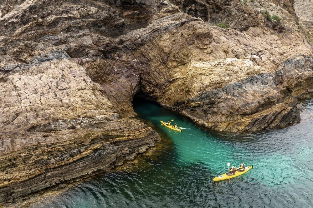 An aerial view of kayakers exploring a cave