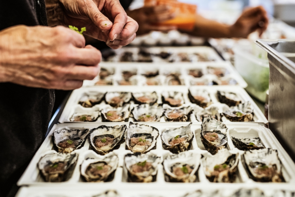 Large trays of oysters laying on a table