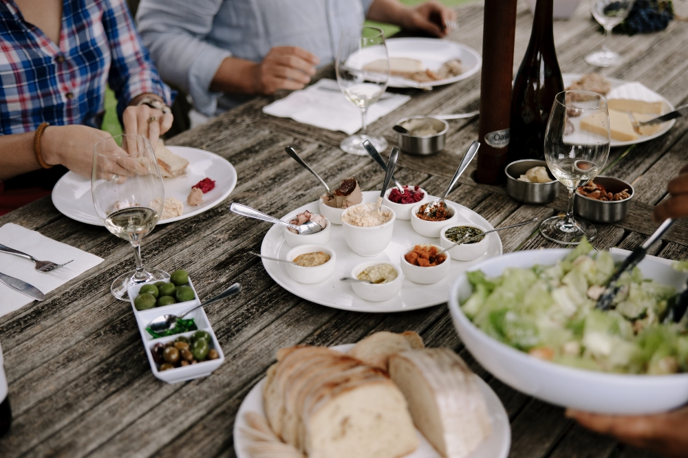 A table spread with cheese and dip platters