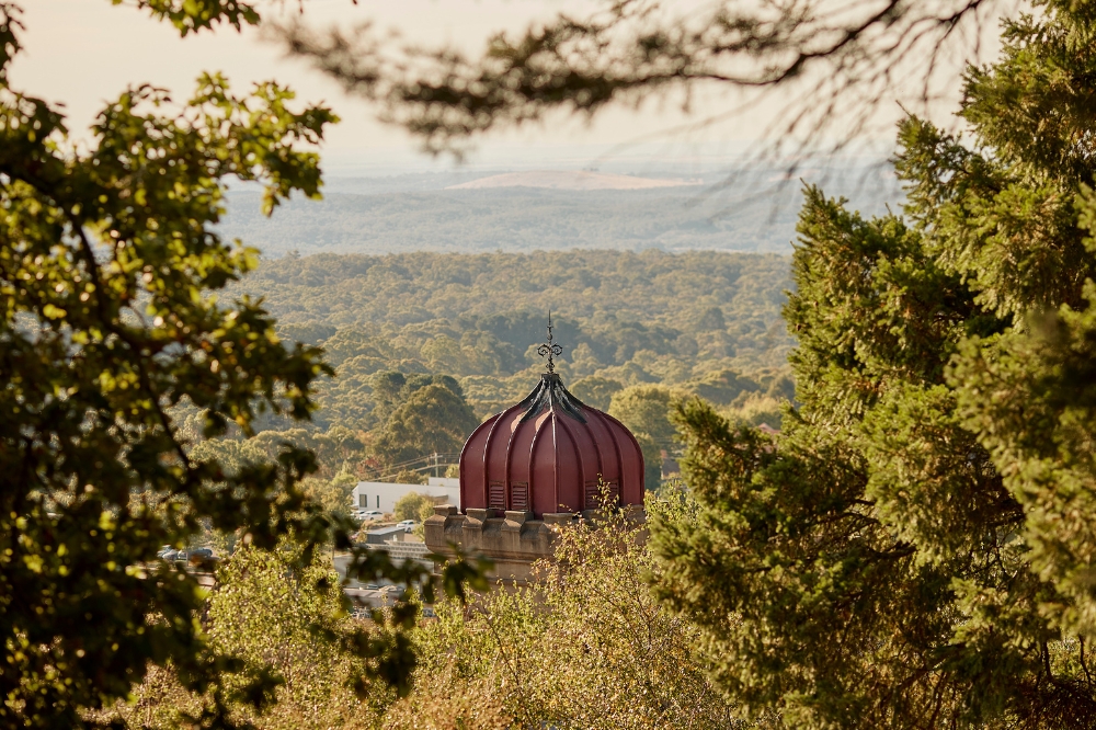A view of the top of The Convent Daylesford with vast trees in the background
