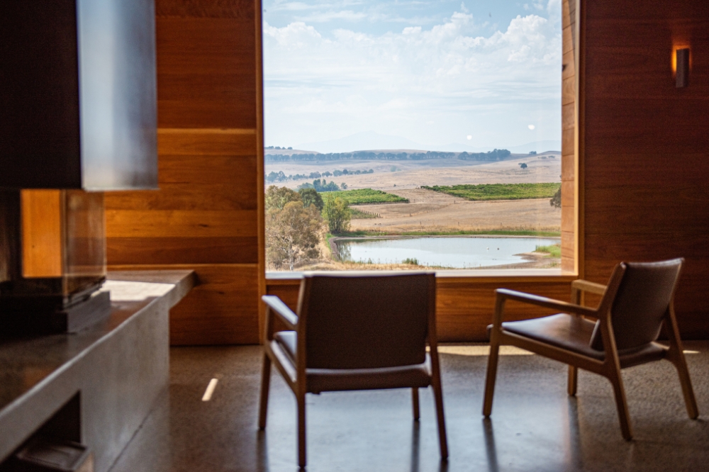 Two chairs look out at the views from a winery window