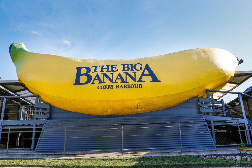 Sun shining over the sign welcoming visitors to The Big Banana attraction in Coffs Harbour