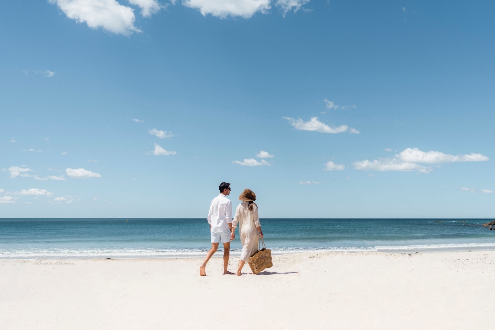 Couple enjoying a sunny day at Forster Beach, Forster.