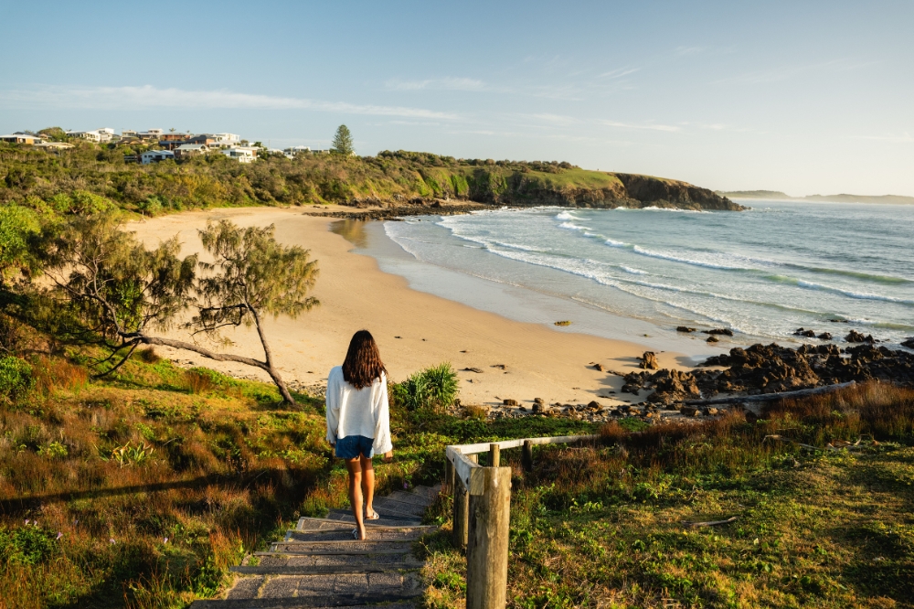Woman heads towards Shelly Beach on the Look At Me Now Headland Walk.