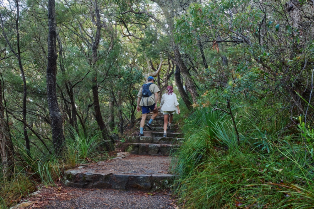 Couple enjoys Tomaree Coastal Walk, Port Stephens. The 27km Tomaree Coastal Walk traverses an ancient volcanic landscape rich in culture and nature
