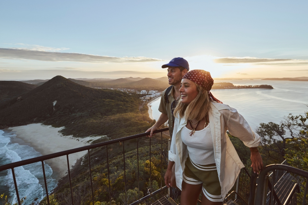 Couple enjoys amazing views on the Tomaree Head Summit walk, a short but challenging hike with picturesque ocean views over Port Stephens and Fingal Island.