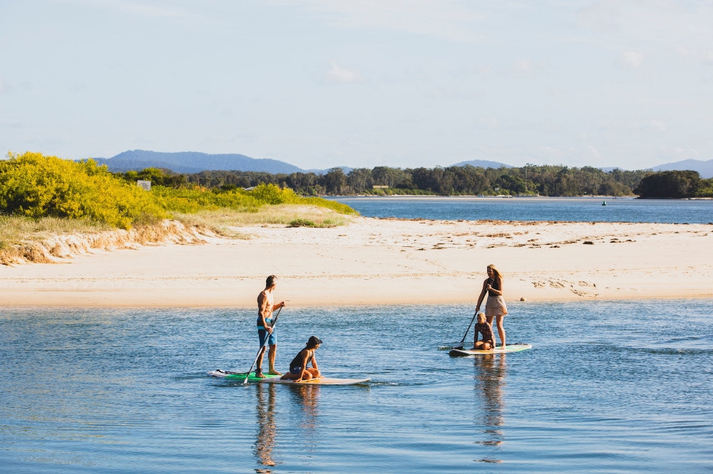Family enjoying a stand up paddleboarding lesson with Jungle Surf on Wallis Lake, Forster-Tuncurry.