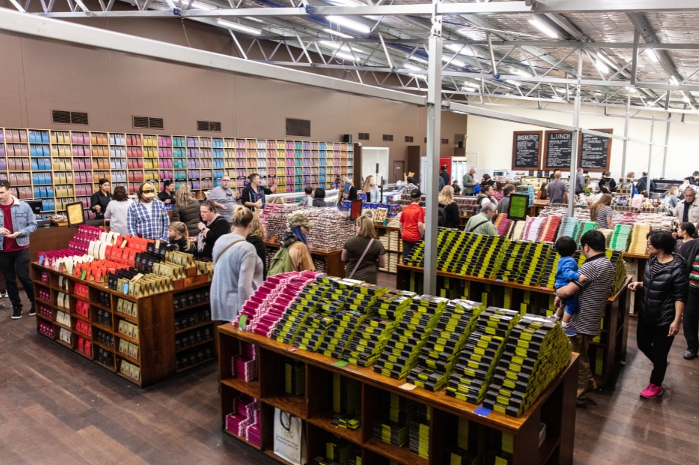 A large chocolate shop filled with people