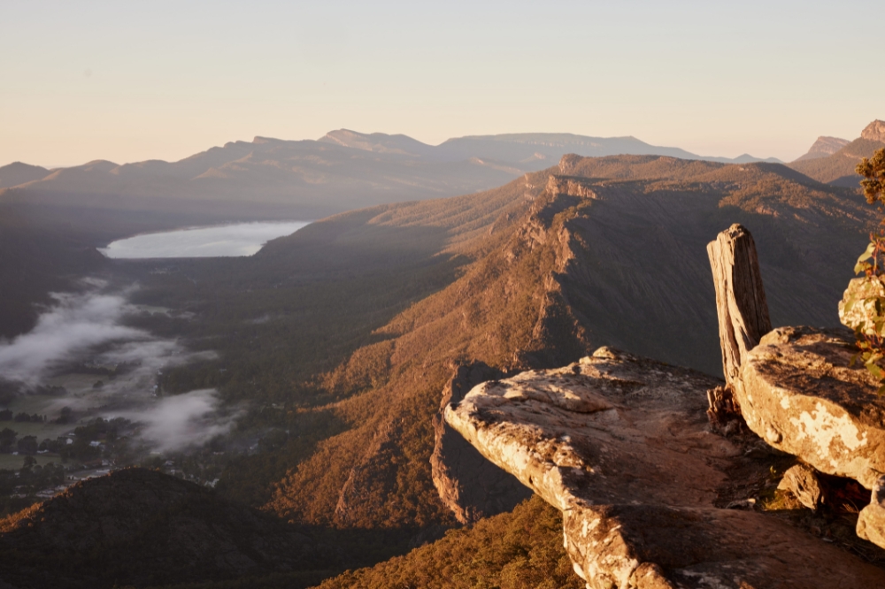 A lookout with a view of a lake and rocky mountains